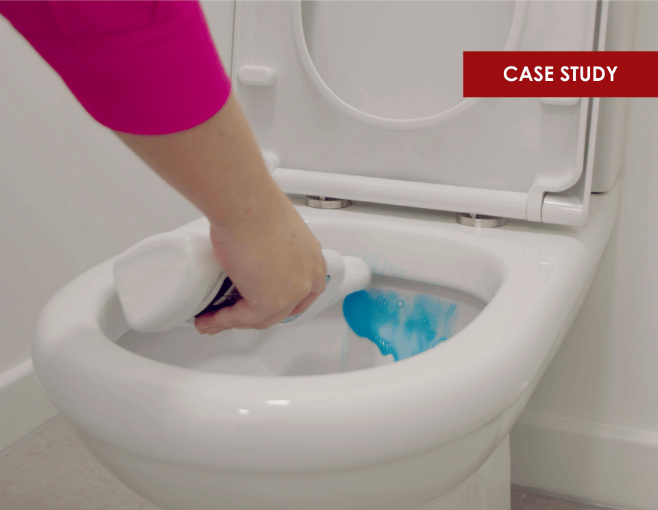 Participant using a cleaning product on a toilet for liquid fragrance research project