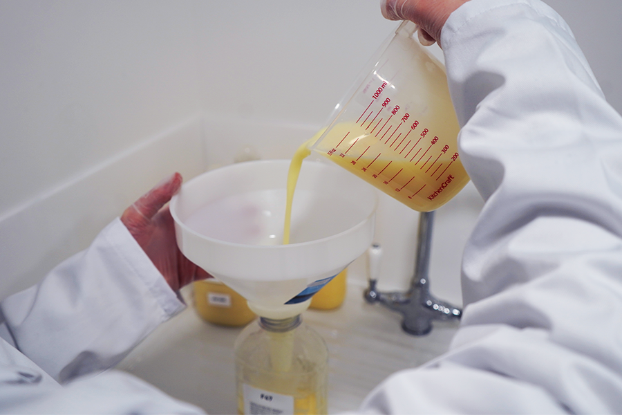 Product Handling 1 A Sense:lab Fieldwork Executive decants a cleaning product into a de-branded container